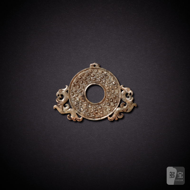 A small jade 'phoenix' disc, bi, Western Han dynasty | 西漢 玉雙鳳紋出廓穀紋璧